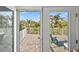 Lovely patio view overlooking lush landscaping, blue skies and other nearby residences at 704 Gladiolus St, Anna Maria, FL 34216