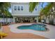 Beautiful pool, private backyard with tropical landscaping and entertainment area is perfect for outdoor gatherings at 704 Gladiolus St, Anna Maria, FL 34216