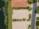Aerial view of homes with tile roofs, manicured lawns, and a community pond at 7164 Rue De Palisades # 5, Sarasota, FL 34238