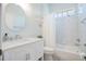 Bright bathroom features a sleek vanity, large mirror, and a combined tub and shower with tile surround at 7164 Rue De Palisades # 5, Sarasota, FL 34238