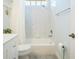 Well-lit bathroom featuring a tub/shower combo, crisp white finishes and modern fixtures at 7164 Rue De Palisades # 5, Sarasota, FL 34238