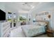 Bright bedroom features a ceiling fan, desk, outside views and lots of natural light at 7164 Rue De Palisades # 5, Sarasota, FL 34238