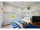 Comfortable bedroom with built-in shelving, a window view, and an abundance of natural light at 7164 Rue De Palisades # 5, Sarasota, FL 34238
