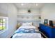 Charming bedroom featuring built-in shelving, calming colors, and a coastal-inspired design at 7164 Rue De Palisades # 5, Sarasota, FL 34238