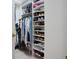 Organized walk-in closet with shelving and hanging rods for clothes and accessories at 7164 Rue De Palisades # 5, Sarasota, FL 34238
