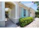 Home exterior showcasing an arched entryway, stucco walls, and a brick-paved walkway at 7164 Rue De Palisades # 5, Sarasota, FL 34238