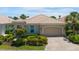 Charming single-story home with a tile roof, attached garage, and well-maintained landscaping at 7164 Rue De Palisades # 5, Sarasota, FL 34238