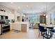 Open-concept kitchen with white cabinetry, stainless steel appliances, and a connected dining area at 7164 Rue De Palisades # 5, Sarasota, FL 34238
