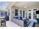 Covered lanai features comfortable seating, a ceiling fan, and access to the home's interior at 7164 Rue De Palisades # 5, Sarasota, FL 34238