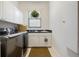Functional laundry room includes a washer, dryer, utility sink, and ample cabinet space at 7164 Rue De Palisades # 5, Sarasota, FL 34238