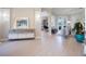 Bright living room with light wood floors, neutral decor, and open access to the kitchen and dining area at 7164 Rue De Palisades # 5, Sarasota, FL 34238