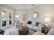 Comfortable living room featuring a round coffee table and large windows offering serene exterior views of the patio at 7164 Rue De Palisades # 5, Sarasota, FL 34238