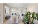 Elegant living room featuring neutral tones, tray ceilings, and sliding glass doors to the outdoors at 7164 Rue De Palisades # 5, Sarasota, FL 34238
