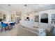 Open living space features a breakfast nook with blue chairs, kitchen with white cabinets, and living room area at 7164 Rue De Palisades # 5, Sarasota, FL 34238