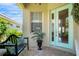 Inviting front porch with a bench, potted plant, and a glass-paneled front door at 7164 Rue De Palisades # 5, Sarasota, FL 34238