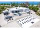 Stunning modern beachfront home with a pool, outdoor bar, and unique parking area at 7647 Sanderling Rd, Sarasota, FL 34242