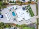 Sprawling estate featuring a pool, outdoor lounge areas, modern architectural details, and lush greenery in a serene setting at 7647 Sanderling Rd, Sarasota, FL 34242