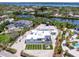 Aerial view of property showcasing a modern home, artificial turf, and waterfront location at 7647 Sanderling Rd, Sarasota, FL 34242