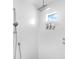 Modern shower area with a rain shower head and wall-mounted fixtures at 7647 Sanderling Rd, Sarasota, FL 34242