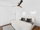 Modern bedroom with sleek lines, stylish lighting, and a comfortable bed with patterned pillows at 7647 Sanderling Rd, Sarasota, FL 34242