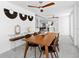 Elegant dining area with modern decor, stylish lighting, and an open view to the kitchen at 7647 Sanderling Rd, Sarasota, FL 34242