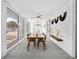 Bright dining area with modern decor, a stylish ceiling fan, and views of the outdoor seating area at 7647 Sanderling Rd, Sarasota, FL 34242