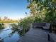 Scenic view of the dock with a cozy bench, perfect for enjoying waterfront tranquility at 7647 Sanderling Rd, Sarasota, FL 34242