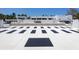 Modern driveway with unique geometric design leading to a stylish white home and landscaping at 7647 Sanderling Rd, Sarasota, FL 34242