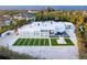 A contemporary white home featuring modern landscaping, geometric turf accents and clean architectural lines at 7647 Sanderling Rd, Sarasota, FL 34242