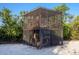 Unique treehouse style structure with natural light and tree trunk detail at 7647 Sanderling Rd, Sarasota, FL 34242
