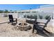 Comfortable backyard with a stone firepit, cozy seating, and well-maintained landscaping perfect for gatherings at 7647 Sanderling Rd, Sarasota, FL 34242