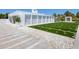Modern home with artificial turf and concrete accents in the front yard at 7647 Sanderling Rd, Sarasota, FL 34242