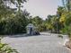 Gated entry to the community with guard house and paved brick drive at 7647 Sanderling Rd, Sarasota, FL 34242