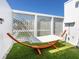 Tranquil backyard space with a comfortable hammock, perfect for relaxation at 7647 Sanderling Rd, Sarasota, FL 34242
