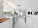 Bright and airy kitchen featuring white countertops, modern appliances, and an open layout at 7647 Sanderling Rd, Sarasota, FL 34242