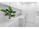 Well-organized laundry room with modern appliances, ample counter space, and a fresh, clean aesthetic at 7647 Sanderling Rd, Sarasota, FL 34242