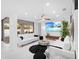 Spacious and modern living room with a wall of windows, sleek furniture, and an open floor plan at 7647 Sanderling Rd, Sarasota, FL 34242