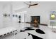 Chic living room featuring a fireplace, sleek furniture, and modern decor at 7647 Sanderling Rd, Sarasota, FL 34242