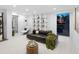 Well-lit living room with contemporary furnishings, a built-in shelf, and large windows offering views at 7647 Sanderling Rd, Sarasota, FL 34242