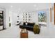 Well-lit living room with contemporary furnishings, a built-in shelf, and large windows offering views at 7647 Sanderling Rd, Sarasota, FL 34242