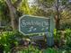 Entrance sign to Sanderling Club, a private road within a lush, green setting at 7647 Sanderling Rd, Sarasota, FL 34242