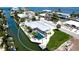 Aerial view of waterfront home with screened pool and boat dockage on canal; close to Intracoastal Waterway at 791 Saint Judes Dr N, Longboat Key, FL 34228