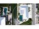 Aerial view showcases the home's location on the water, including a pool, dock, and lush surroundings at 791 Saint Judes Dr N, Longboat Key, FL 34228