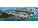 Stunning aerial view of waterfront homes, showing canals, Intracoastal Waterway, and beautiful beaches in the distance at 791 Saint Judes Dr N, Longboat Key, FL 34228