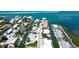 Aerial view of home with pool on canal, with easy access to the Intracoastal Waterway at 791 Saint Judes Dr N, Longboat Key, FL 34228