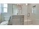 Modern bathroom featuring gray vanity, glass shower, and tiled walls at 791 Saint Judes Dr N, Longboat Key, FL 34228