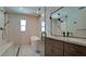 Modern bathroom featuring a soaking tub, walk-in shower with glass door and vanity at 791 Saint Judes Dr N, Longboat Key, FL 34228