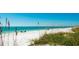 Serene beach view with white sand, clear blue water, and calm atmosphere at 791 Saint Judes Dr N, Longboat Key, FL 34228