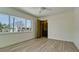 Bright bedroom with wood-look tile, large window, and ensuite bathroom at 791 Saint Judes Dr N, Longboat Key, FL 34228