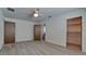 Spacious bedroom with wood-style tile flooring, a ceiling fan, and two door entries at 791 Saint Judes Dr N, Longboat Key, FL 34228